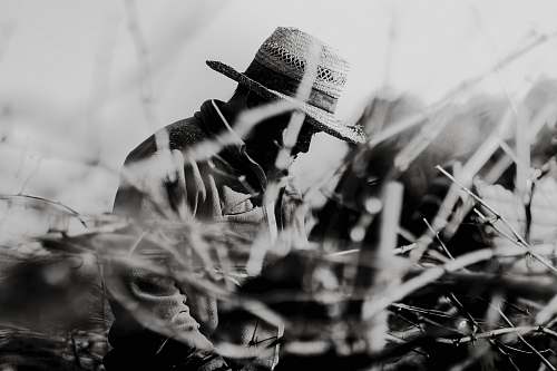 canary islands grayscale photography of man wearing hat spain